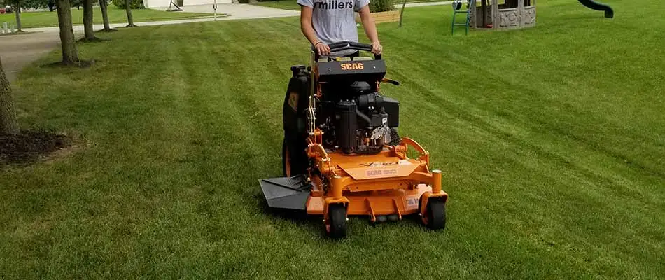 Sprout Lawn & Landscape lawn care worker mowing a yard at the proper height in Carmel, IN.