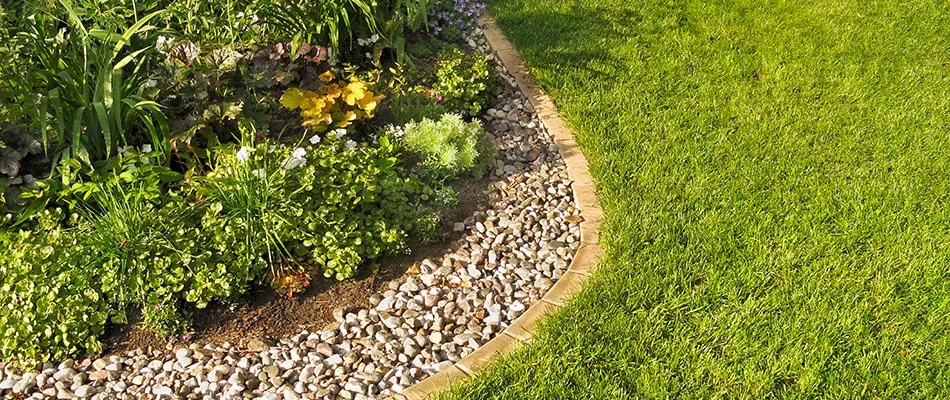 A newly installed landscape bed with mulch and rock by a home in Noblesville, IN. 