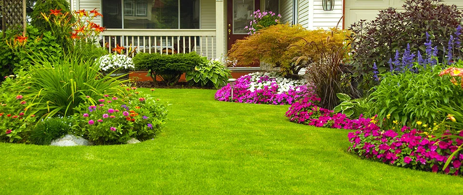 A white home with colorful landscaping in Fishers, IN. 