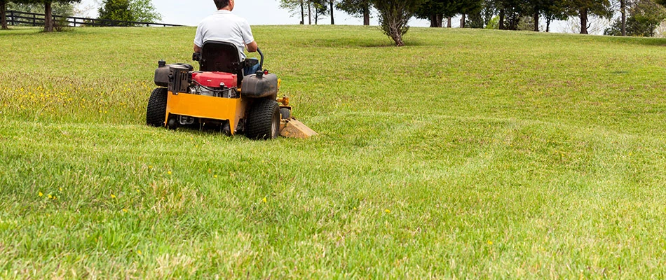 Our lawn maintenance specialist mowing a lawn by a home in Carmel, IN. 