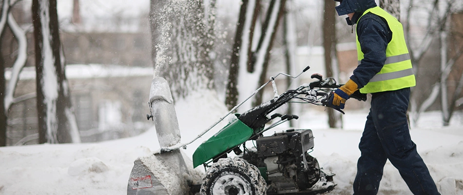 Our professional removing snow from a sidewalk in Carmel, IN. 